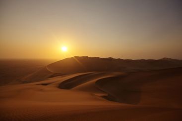 Sunset, sky and landscape of sand dunes in desert for...