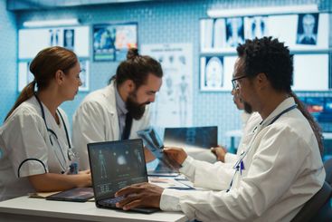 Physicians examining x ray scan results in a meeting...