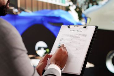 Diverse Professional Inspecting Car Damage for Insurance...