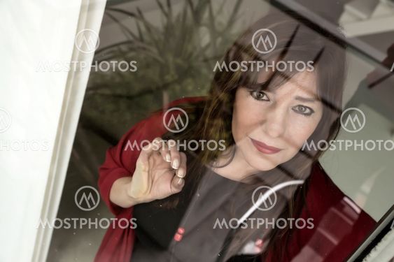 Mature woman looking out the window