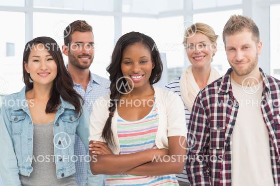 Young team of designers standing and smiling at camera