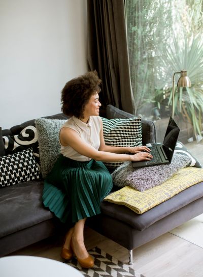 Attractive young woman working on laptop at home