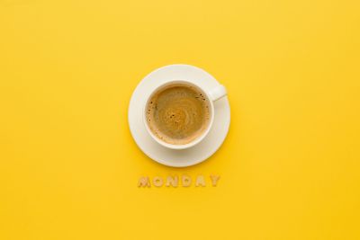 top view of cup of espresso coffee and monday lettering...