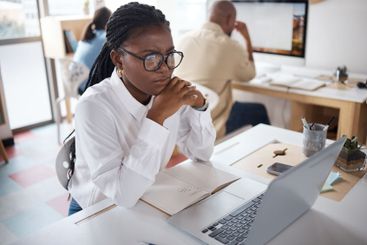 African businesswoman, confused or reading on laptop for...