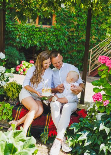 Mom and dad in nature with their one-year-old son...