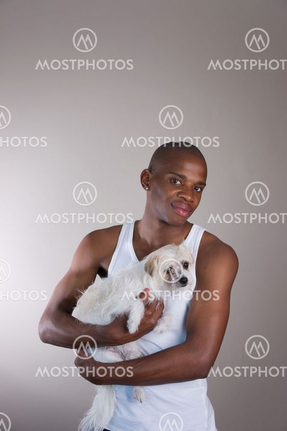 Good looking African man holding his dog