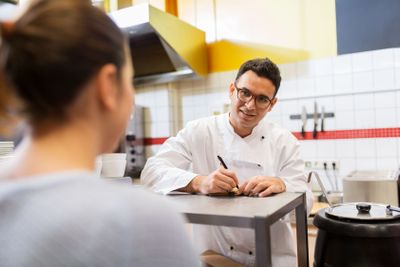 chef at fast food restaurant writing order