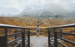 Traveler man in mountains of Norway autumn season travel