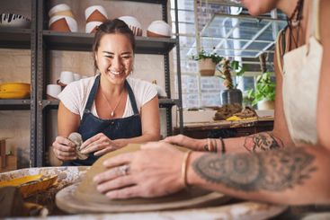 People, wheel and pottery class in studio, working...