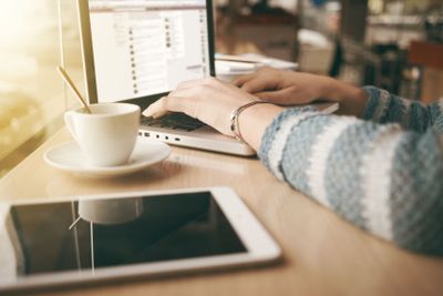 Woman using a laptop during a coffee break