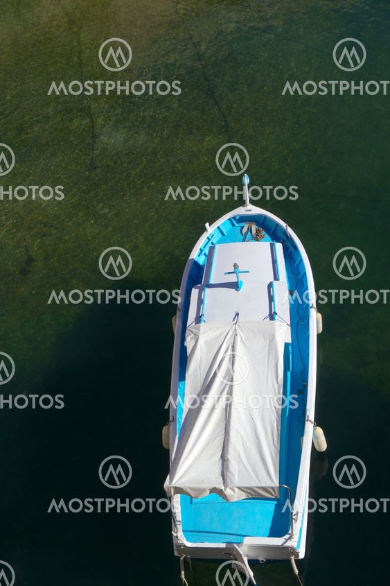 single blue boat from above