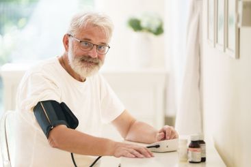 Senior man measuring blood pressure