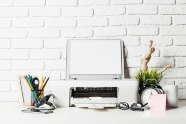 Home office workspace showcasing a printer, stationary,...