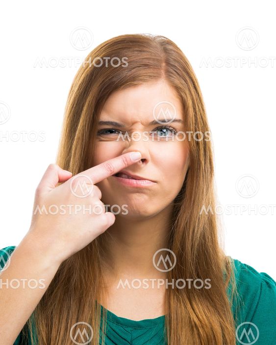 Beautiful young woman touching the nose