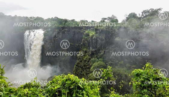 A powerful stream of water falls into the abyss.