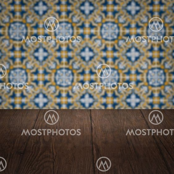 Wood table top and blur vintage ceramic tile pattern wall