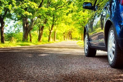 Car on asphalt road in summer