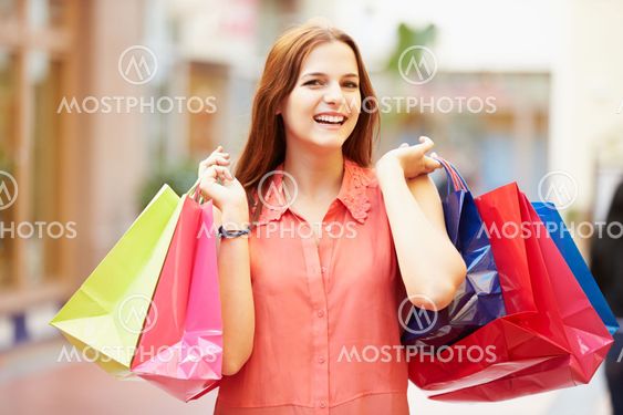 Woman Walking Through Mall Carrying Shopping Bags