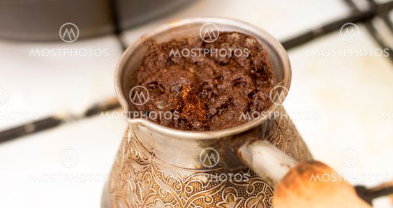 Hot tasty coffee traditionally prepearing in old turk