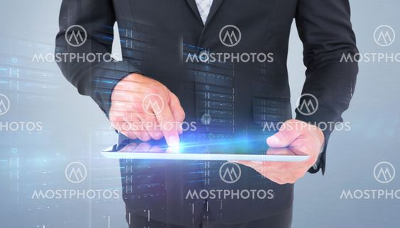 Composite image of businessman using his tablet pc