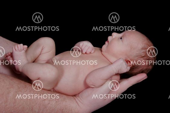Newborn Baby Held in Her Daddy's Arms
