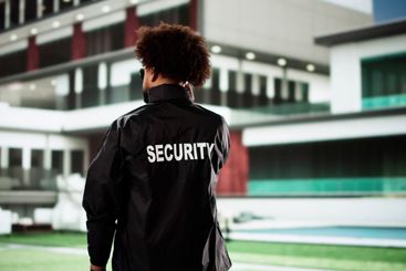 Male police officer safeguarding property outside