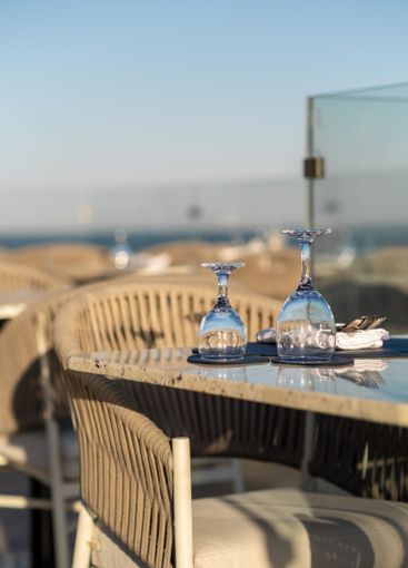 Sophisticated sunset dining setup at a seaside...