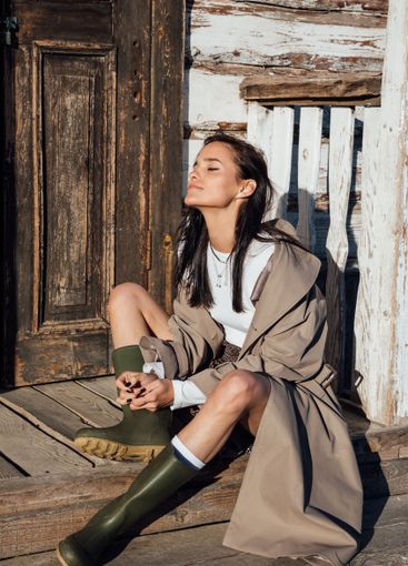 Beautiful fashionable brunette woman in gray coat on...