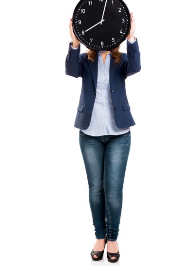 Business woman holding a big clock
