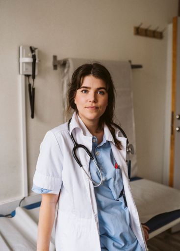 Portrait of female healthcare worker leaning on examining...