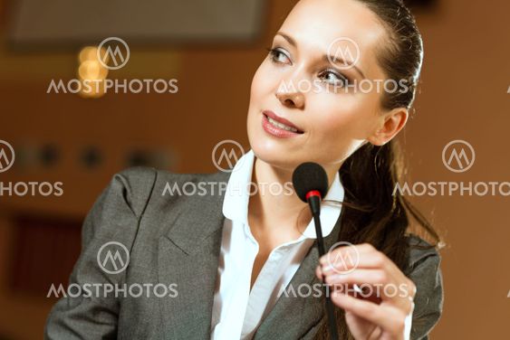 Portrait of a business woman with microphone