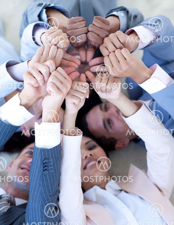 Business team on floor in a circle with thumbs up