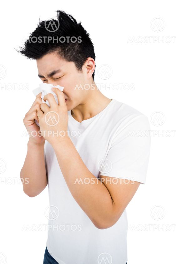Young man wiping his nose