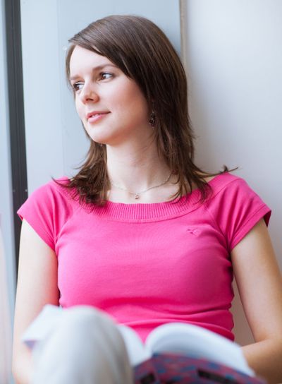 pretty, female college student in a library (shallow DOF;...
