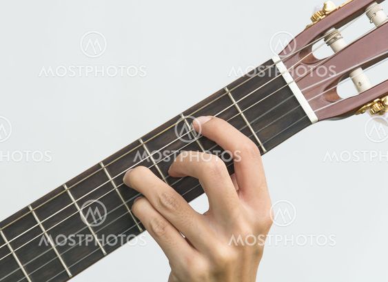 hand playing on guitar