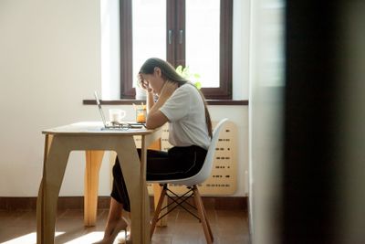 Tired sleepy businesswoman sitting at working place