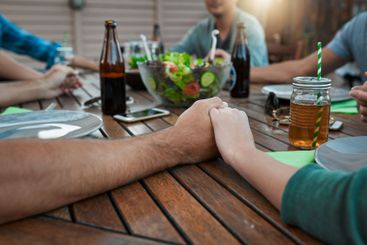 Christian, holding hands and prayer in group, lunch and...