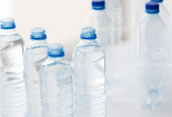 close up of bottles with drinking water on table