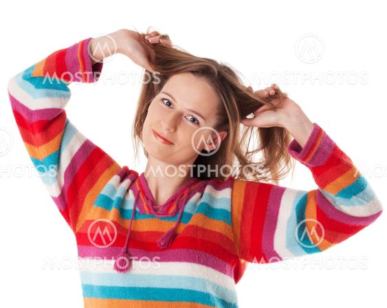 Young happy woman smiling grabs her hair