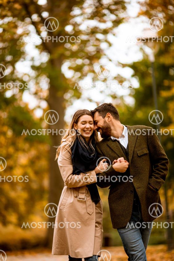 Young couple walking in the autumn park