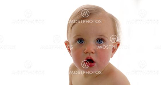 Portrait of a surprised baby with big blue eyes