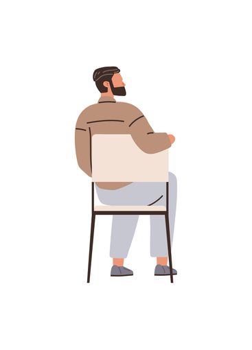 Man Sitting on a Chair with His Back Turned in Casual...