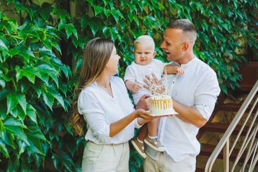 Mom and dad in nature with their one-year-old son...