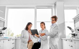 scientists with tablet pc working in laboratory