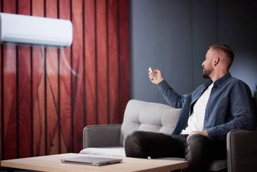 Man Using Conditioner In Room