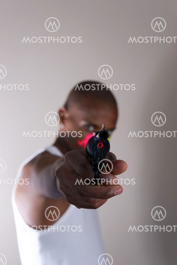 Young African man pointing a gun