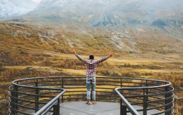 Traveler man in mountains of Norway autumn season travel