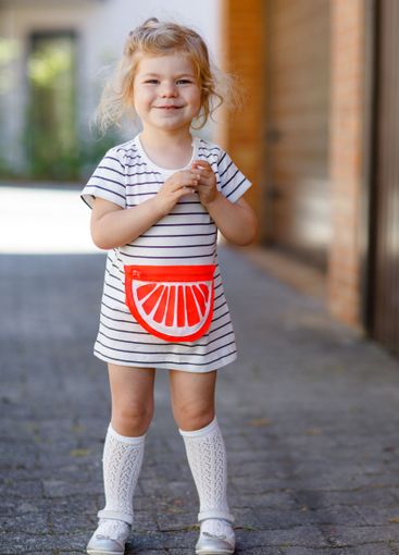 Portrait of beautiful little toddler girl in summer look...