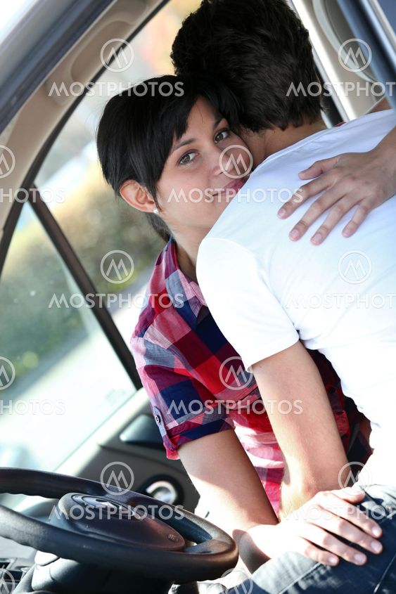 Embracing couple in a car