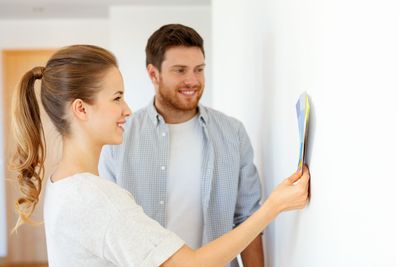 happy couple with color samples at new home